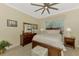 Comfortable bedroom featuring a large bed, a ceiling fan, a dresser with a mirror, and natural lighting at 13051 Creekside Ln, Port Charlotte, FL 33953