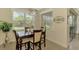 Dining area with tile floors, modern chandelier, and natural light at 13051 Creekside Ln, Port Charlotte, FL 33953