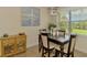 Cozy dining room featuring a dark wood table set, rattan accent furniture and bright, natural lighting at 13051 Creekside Ln, Port Charlotte, FL 33953