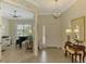 Open foyer with tile floors, decorative chandelier, and view into the living room at 13051 Creekside Ln, Port Charlotte, FL 33953