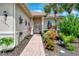 Charming front entrance with brick path and lush landscaping with a decorative wreath at 13051 Creekside Ln, Port Charlotte, FL 33953