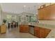 Kitchen view featuring granite countertops, stainless dishwasher, tile backsplash and view to dining area at 13051 Creekside Ln, Port Charlotte, FL 33953