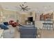 Open floor plan living room featuring tile floors, a ceiling fan, and view of the kitchen at 13051 Creekside Ln, Port Charlotte, FL 33953