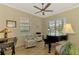 Home office with lots of natural light, features a piano, desk, and comfortable chair at 13051 Creekside Ln, Port Charlotte, FL 33953