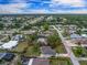 Aerial view of a home in a neighborhood surrounded by lush landscaping, highlighting property's serene setting at 1337 Le Pera Rd, Englewood, FL 34223