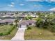 Aerial view of a well-kept neighborhood with lush landscaping and a long driveway to the home at 1337 Le Pera Rd, Englewood, FL 34223