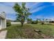 The lush green backyard features mature trees and plenty of space for recreation or gardening projects at 1337 Le Pera Rd, Englewood, FL 34223