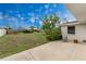 Large backyard with a concrete patio and chair, offering an ideal space for relaxing and enjoying the outdoors at 1337 Le Pera Rd, Englewood, FL 34223