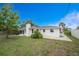 Spacious backyard with a chimney, offering ample room for gardening and outdoor activities on a sunny day at 1337 Le Pera Rd, Englewood, FL 34223