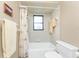 Clean bathroom showing a shower-tub combo, neutral tile, and standard fixtures at 1337 Le Pera Rd, Englewood, FL 34223