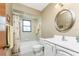 Traditional bathroom featuring a shower-tub combo with white fixtures and neutral tones at 1337 Le Pera Rd, Englewood, FL 34223