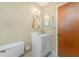 Bathroom features white vanity, round mirror, and standard toilet at 1337 Le Pera Rd, Englewood, FL 34223