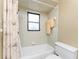 Clean bathroom showing a shower-tub combo, neutral tile, and standard fixtures at 1337 Le Pera Rd, Englewood, FL 34223