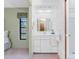Bathroom with white vanity, sink, and view into the walk-in shower at 1337 Le Pera Rd, Englewood, FL 34223