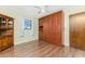 Bedroom showcasing a built-in wardrobe, wood laminate flooring, and natural light at 1337 Le Pera Rd, Englewood, FL 34223