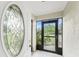 Inviting front entrance featuring a decorative glass door and view of the outside landscaping at 1337 Le Pera Rd, Englewood, FL 34223