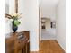 Inviting hallway with tile flooring leading to living areas, featuring a vintage radio and decorative mirror at 1337 Le Pera Rd, Englewood, FL 34223