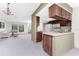 Open floor plan with kitchen featuring wood cabinets and white appliances, connected to the living room at 1337 Le Pera Rd, Englewood, FL 34223