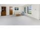 Bright living room with neutral carpet and natural light, showcasing a comfortable seating area and wooden storage at 1337 Le Pera Rd, Englewood, FL 34223