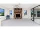Living room featuring a ceiling fan, stone fireplace and a sliding glass door at 1337 Le Pera Rd, Englewood, FL 34223