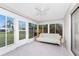 Bright sunroom features tile flooring, ceiling fan, and windows offering views of the yard at 1337 Le Pera Rd, Englewood, FL 34223