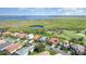 Lovely aerial view showcases a well-maintained community with views of both a golf course and a pond at 13376 Golf Pointe Dr, Port Charlotte, FL 33953