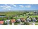 Serene aerial view of a neighborhood near a marsh and a golf course shows houses with manicured lawns at 13376 Golf Pointe Dr, Port Charlotte, FL 33953