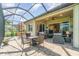 Expansive screened-in lanai and outdoor seating area, perfect for enjoying the beautiful Florida weather at 13376 Golf Pointe Dr, Port Charlotte, FL 33953
