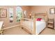 Bedroom featuring a full bed, carpet flooring, a large window and a side table at 13376 Golf Pointe Dr, Port Charlotte, FL 33953