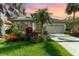 Charming home featuring lush landscaping, a tile roof, and a well-manicured lawn at 13376 Golf Pointe Dr, Port Charlotte, FL 33953