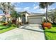 Charming home featuring lush landscaping, a tile roof, and a well-manicured lawn at 13376 Golf Pointe Dr, Port Charlotte, FL 33953