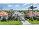 Attractive home with lush landscaping, healthy palm trees, and a well-manicured lawn located on a golf course at 13376 Golf Pointe Dr, Port Charlotte, FL 33953