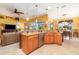 Modern kitchen with stainless appliances, granite countertops, and an island with seating at 13376 Golf Pointe Dr, Port Charlotte, FL 33953