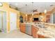The kitchen has granite countertops, stainless steel appliances and a view of the living area at 13376 Golf Pointe Dr, Port Charlotte, FL 33953
