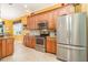 Kitchen features stainless appliances, tile backsplash, and warm wood cabinets at 13376 Golf Pointe Dr, Port Charlotte, FL 33953