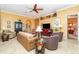 Comfortable living room featuring warm colors, tile floors, and an open layout at 13376 Golf Pointe Dr, Port Charlotte, FL 33953