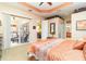 The main bedroom has a slider to the lanai, carpet flooring, and a view of the ensuite at 13376 Golf Pointe Dr, Port Charlotte, FL 33953