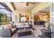 Inviting screened-in patio with wicker furniture, ceiling fan, and seamless access to the kitchen at 13376 Golf Pointe Dr, Port Charlotte, FL 33953