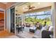 Relaxing screened-in lanai with comfortable seating and picturesque views of the lush backyard at 13376 Golf Pointe Dr, Port Charlotte, FL 33953