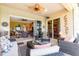 Spacious screened-in lanai with comfortable seating, ceiling fan, and serene outdoor ambiance at 13376 Golf Pointe Dr, Port Charlotte, FL 33953