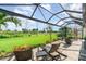 Relaxing backyard patio with comfortable seating and scenic views of the lush green landscape at 13376 Golf Pointe Dr, Port Charlotte, FL 33953