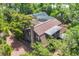 This is an aerial view showcasing the home's wooded lot and screened-in enclosure at 1550 Bayshore Dr, Englewood, FL 34223