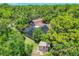 Overhead view of estate surrounded by lush greenery, large home, lush landscaping and screened pool area at 1550 Bayshore Dr, Englewood, FL 34223