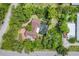 Aerial view of property showcasing mature trees, screened-in pool, and landscaping at 1550 Bayshore Dr, Englewood, FL 34223