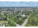 Expansive aerial view showing the neighborhood with lush greenery, waterways, and various residential homes under a bright sky at 1550 Bayshore Dr, Englewood, FL 34223