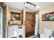 Bathroom featuring a shower with pebble floor, white vanity, bronze fixtures, and an adjacent window at 1550 Bayshore Dr, Englewood, FL 34223