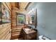 Bathroom featuring a vanity with wood accents, a large mirror, and wood log walls at 1550 Bayshore Dr, Englewood, FL 34223