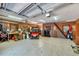 Spacious garage featuring a golf cart, utility sink, exposed beams, washer and dryer, and epoxy floor at 1550 Bayshore Dr, Englewood, FL 34223