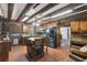 Rustic kitchen with wooden cabinets, granite countertops, stainless steel appliances, and terra cotta floors at 1550 Bayshore Dr, Englewood, FL 34223