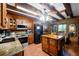 Traditional style kitchen features wooden cabinets, granite countertops, black appliances, and terra cotta floors at 1550 Bayshore Dr, Englewood, FL 34223